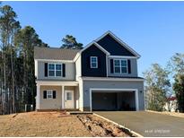 Two-story home featuring a gray exterior, black shutters and a two-car garage at 60 Bennett Rd, Coats, NC 27521