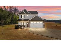 Two-story house with gray and white siding, two-car garage, and landscaped yard at 1264 Hayes Rd, Spring Lake, NC 28390