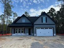 Gray exterior of charming new construction home with a two-car garage at 6967 Old Jefferson Davis Hwy, Cameron, NC 28326