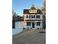Two-story house with gray siding, black shutters, and a two-car garage at 772 Roberts Rd, Sanford, NC 27332