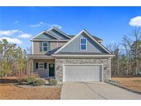 Two-story house with stone accents and a two-car garage at 886 Juno Dr, Broadway, NC 27505