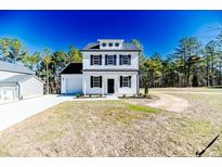 Charming two-story home with a well-maintained lawn and a classic black-and-white color scheme at 806 Roberts Rd, Sanford, NC 27332