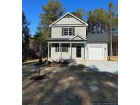 Two-story house with gray siding, black door, and attached garage at 826 Roberts Rd, Sanford, NC 27332