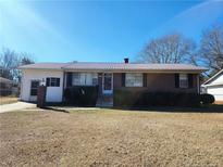 Brick ranch house with attached garage and well-maintained lawn at 2712 Cameron Dr, Sanford, NC 27332