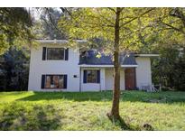 Two-story home featuring white siding, black shutters, and a well-maintained lawn at 1615 Carbonton Rd, Sanford, NC 27330