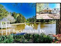 Beautiful property featuring a serene lake with a charming gazebo and the home in the background at 2648 Buckingham Dr, Sanford, NC 27330