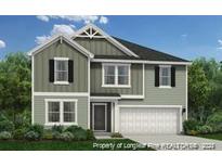 Two-story home with green siding, attached garage, and landscaping at 22 Bennington Way, Lillington, NC 27546