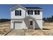 Charming two-story home with white siding, dark shutters, and an attached one-car garage at 313 Greenbay St, Lillington, NC 27546