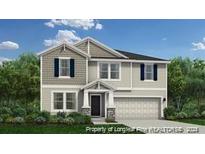 Two-story home with gray siding, stone accents, and a two-car garage at 335 Greenbay (Lot 573) St, Lillington, NC 27546