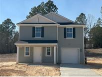 Charming two-story home with attached one-car garage and newly installed concrete driveway at 4 Bennington Way, Lillington, NC 27546