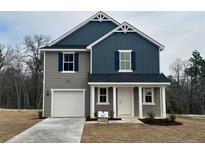 Charming two-story home with a modern design, gray and blue siding, and a one-car garage at 43 Bennington Way, Lillington, NC 27546