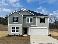 Charming two-story home boasts a classic design with a modern two-car garage and welcoming entrance at 9 Bennington Way, Lillington, NC 27546