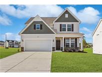 Two-story house with gray siding, white trim, and a two-car garage at 11 Steeple Rdg, Cameron, NC 28326