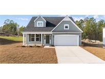 Two-story house with gray siding, white trim, and a two-car garage at 51 Steeple Rdg, Cameron, NC 28326