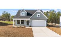 Charming single-Gathering home with a two-car garage, manicured lawn, and inviting front entrance at 51 Steeple Rdg, Cameron, NC 28326