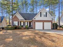 Brick front house with two-car garage and landscaped yard at 85 Shining Water Ln, Spring Lake, NC 28390