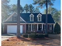 Brick and siding two-story house with a large yard at 60 Rolling Pines Dr, Spring Lake, NC 28390