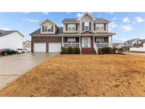 Two-story brick home with a two car garage and landscaped lawn at 105 Caldwell St, Spring Lake, NC 28390