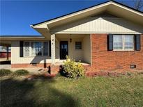 Charming home with a brick facade, inviting front porch, and well-maintained landscaping at 108 George St, Dunn, NC 28334