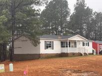 Single-wide mobile home with front porch and yard at 192 Washington Ln, Cameron, NC 28326