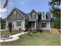 Two-story house with gray siding, large windows, and a landscaped yard at 224 Melody Ln, Cameron, NC 28326