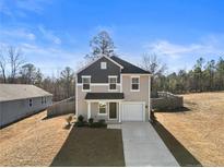 Two-story house with gray and beige siding, attached garage, and driveway at 28 York Ct, Spring Lake, NC 28390