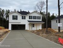 Two-story house with attached garage and driveway at 283 Rocking Horse Ln, Sanford, NC 27332