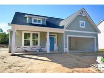 Newly constructed home with gray siding, two-car garage, and front porch at 2919 Lemuel Black Rd, Bunnlevel, NC 28323