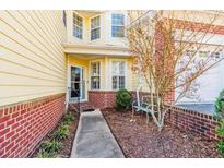 Inviting front entry with walkway, landscaping, and a charming bench at 82 Pine Hawk Dr, Spring Lake, NC 28390