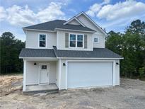 Charming two-story home features a 2-car garage and classic architectural details at 48 Tackett Ct, Lillington, NC 27546
