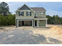 Charming new two-story home featuring a large garage, landscaped yard, and craftsman-style details at 24 Tackett Ct, Lillington, NC 27546