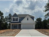 Charming two-story home featuring a classic blue and white exterior and an attached two-car garage at 39 Tackett Ct, Lillington, NC 27546