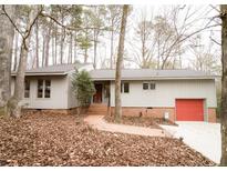 Ranch style home with brick accents and a red garage door at 5005 Dove Path, Sanford, NC 27332