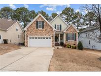 Charming two-story home with a two-car garage and stone and siding exterior at 55 London Way, Spring Lake, NC 28390