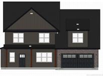 Two-story home with dark gray siding, stone accents, and a two-car garage at 115 Mahogany Ct, Cameron, NC 28326