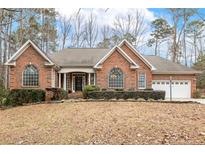 Brick house with attached garage, landscaping, and a spacious front yard at 1156 Deerfoot Trl, Sanford, NC 27332