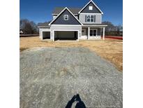 Charming two-story home featuring a two-car garage and classic architectural details at 123 Surles Landing Way, Benson, NC 27504