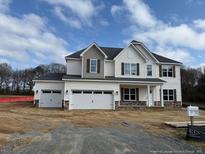 Charming two-story home showcasing a two-car garage and contrasting trim, with meticulous attention to architectural detail at 145 Surles Landing Way, Benson, NC 27504