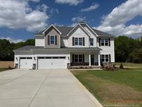 Beautiful two story home with three car garage and manicured front lawn at 145 Surles Landing Way, Benson, NC 27504