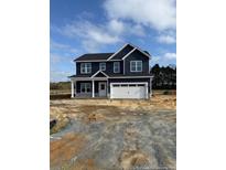 Newly constructed two-story home with a white two-car garage and covered porch at 23 Surles Landing Way, Benson, NC 27504