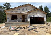 New construction home featuring a garage and a concrete foundation in a wooded neighborhood at 224 Appaloosa - Lot 60 Dr, Spring Lake, NC 28390