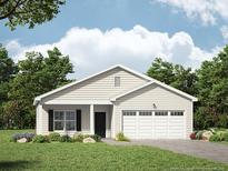 One-story home with beige siding, two-car garage, and landscaping at 224 Appaloosa - Lot 60 Dr, Spring Lake, NC 28390