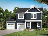 Two-story house with dark siding, white garage doors, and landscaping at 238 Appaloosa - Lot 61 Dr, Spring Lake, NC 28390