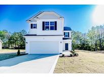Charming two-story home featuring a pristine white exterior, black shutters, and well-manicured lawn at 69 Onslow Ct, Spring Lake, NC 28390