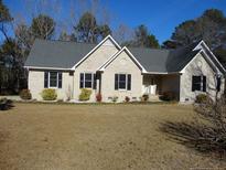 Charming one-story brick home with a well-maintained lawn and manicured landscaping at 849 Melody Ln, Cameron, NC 28326
