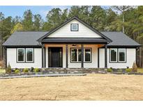 Charming, single story home with black frame windows and a stone accent base at 107 Georgie Dr, Broadway, NC 27505