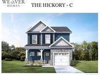 Two-story home with blue siding, white garage door, and gray stone accents at 4214 Darroch Rd, Lillington, NC 27546