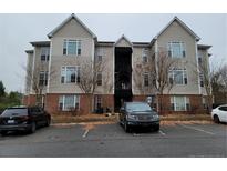 Beige 3-story building with multiple windows and parking at 2510 Friedland Pl # 200, Raleigh, NC 27617