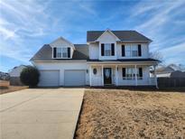 Two-story house with a three-car garage and a spacious front yard at 281 Highland Forest Dr, Sanford, NC 27332