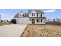 Charming two-story home with a two-car garage and a welcoming front porch at 281 Highland Forest Dr, Sanford, NC 27332